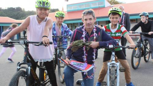 Karl Woolcott of RIDE holidays made some kids at Taita Central School very happy with free school bikes